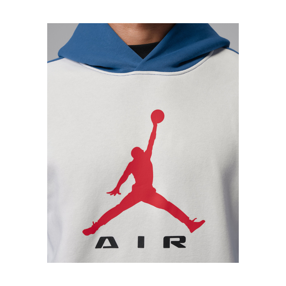 A close-up of a white sweatshirt with a blue hood and a large red Jordan logo on the chest, with the word 'AIR' printed below in black.