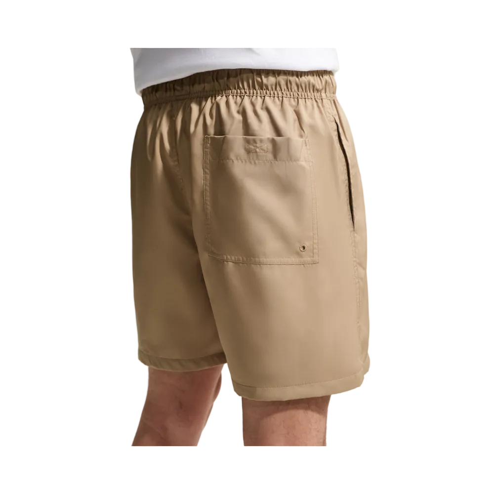 Beige casual shorts with an elastic waistband, side pockets, and a large back pocket, shown on a model from the waist down.