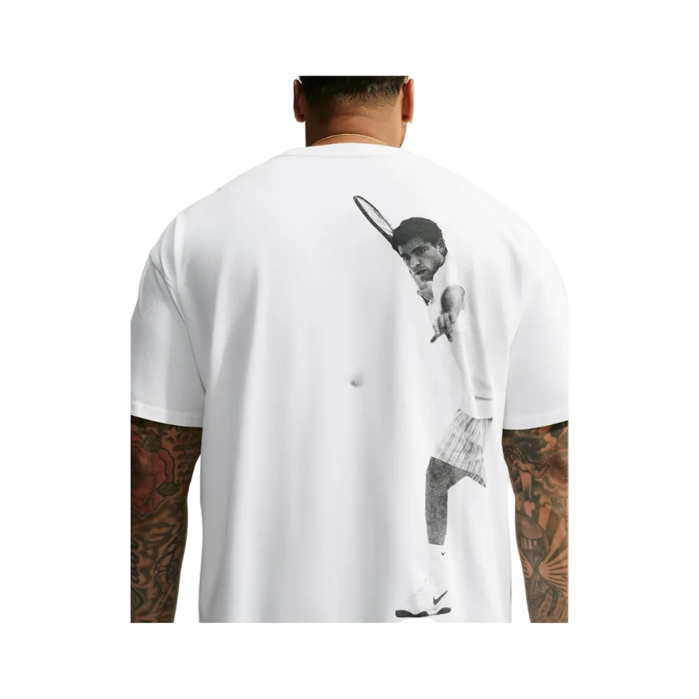 A man viewed from the back wearing a white t-shirt with a large black-and-white graphic print of a tennis player on the back.